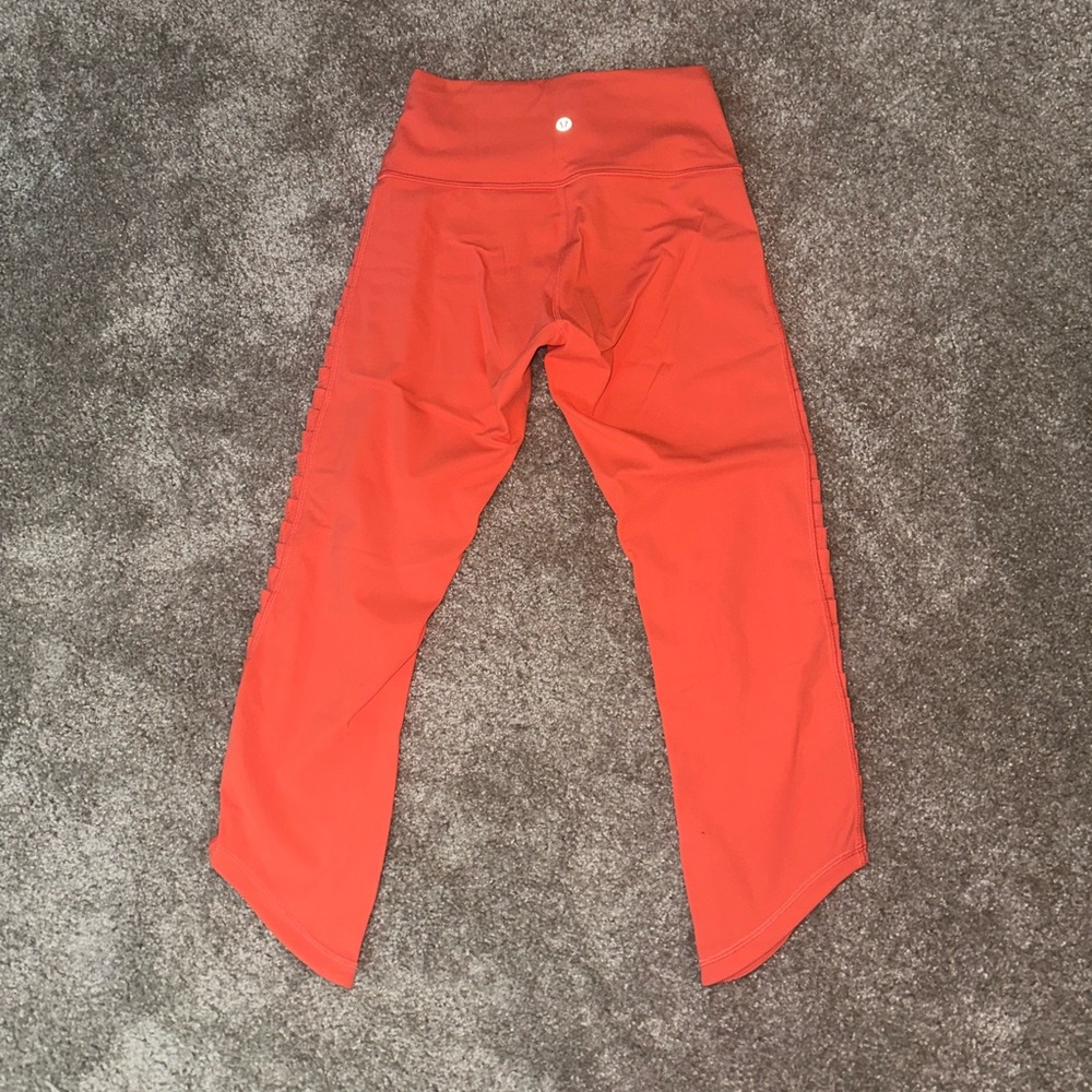 Pretty orange, lululemon capri leggings with ruffles on side—-worn 1 or 2 times